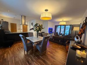 a living room with a table and a couch at Regent View Apartment in Knutsford