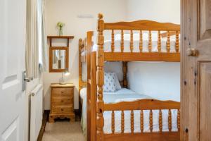 a bedroom with two bunk beds and a mirror at 3 Bed in Whitwell oc-h33498 in Whitwell