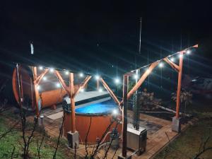 a swimming pool at night with lights at Agroturystyka Pod Gruszą in Chyrowa
