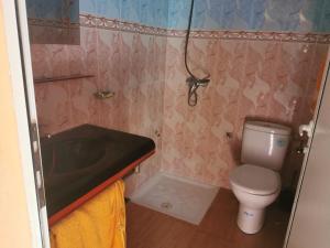 a bathroom with a toilet and a sink and a tub at Motel in Oulad Barrehil