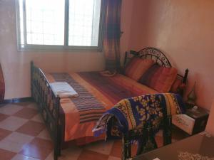 a bedroom with a bed and a window at Motel in Oulad Barrehil