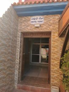 an entrance to a brick building with a sign on it at Motel in Oulad Barrehil