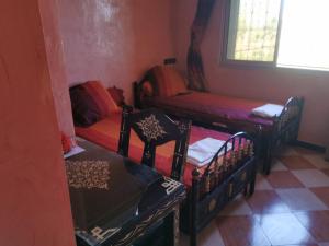 a room with two beds and a couch and a window at Motel in Oulad Barrehil +6 photos