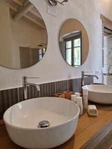 a bathroom with a white sink and a mirror at Casa S'Urtzula in Sini