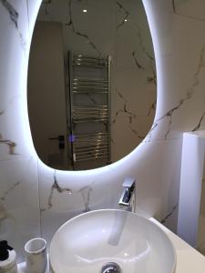 un baño con lavabo y espejo en Azure Mirage Home Adults Only Private Seaside Villa w Garden and Parking, en Faliraki 39 fotos más