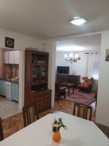 a kitchen and living room with a table and chairs at Dve Breze 