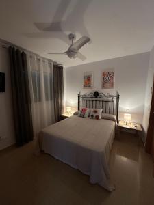 a bedroom with a bed with two lamps on it at Pegaso II in San Juan de los Terreros +17 photos