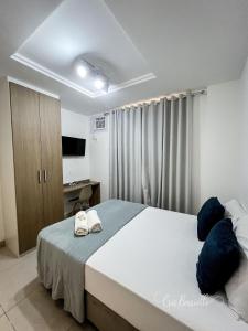 a bedroom with a large bed and a television at Studio Novíssimo Mauá 1108 in Rio de Janeiro +12 photos