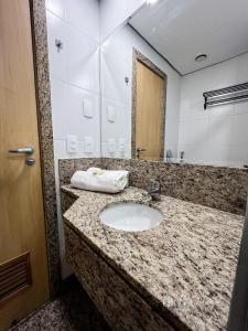 a bathroom with a sink and a mirror at Studio Novíssimo Mauá 1108 in Rio de Janeiro