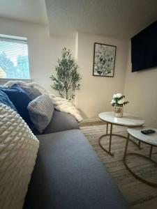 a living room with a couch and a table at Cozy and well located 2-bedroom basement in Provo