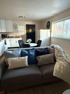 a living room with a couch with pillows at Cozy and well located 2-bedroom basement in Provo