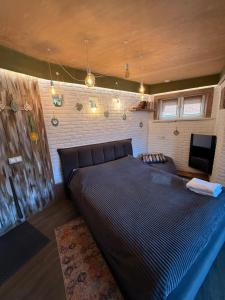 a large bed in a room with a tv at Dobri Dom in Karagayly