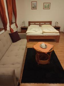 a living room with a couch and a table at Penzion Scarlet in Trenčín