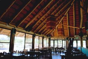 a dining room with tables and chairs in a building at Termas Concepcion in Concepción del Uruguay