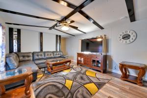 a living room with a couch and a flat screen tv at Heart of Greensboro Pet-Friendly Gem 3 Mi to Dtwn in Fisher Park