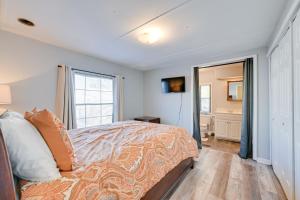 a bedroom with a bed and a bathroom at Heart of Greensboro Pet-Friendly Gem 3 Mi to Dtwn in Fisher Park