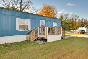 a blue house with a deck on the side of it at Heart of Greensboro Pet-Friendly Gem 3 Mi to Dtwn in Fisher Park