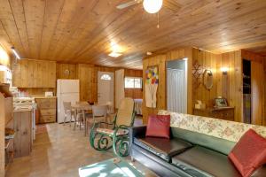 ein Wohnzimmer mit Couch und Küche in der Unterkunft Cozy Rivershire Retreat Cabin Near Traverse City in Devils Elbow