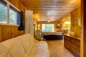 ein Wohnzimmer mit einer weißen Couch in einem Zimmer in der Unterkunft Cozy Rivershire Retreat Cabin Near Traverse City in Devils Elbow