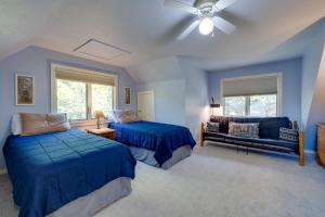 a blue bedroom with two beds and a couch at Riverside Serenity - Rivershire Retreat Guesthouse in Devils Elbow