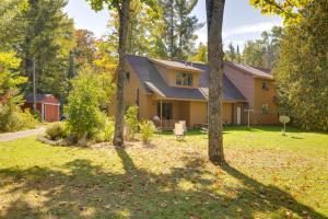 a house with a yard with trees at Riverside Serenity - Rivershire Retreat Guesthouse in Devils Elbow