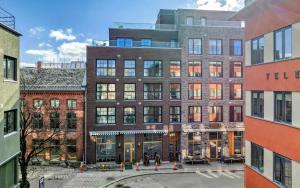 a large brick building with people walking in front of it at Modern downtown apartment in Fredrikstad