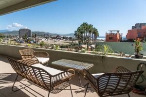 a group of chairs and a table on a balcony at The Point At Cerritos # 4 in San Carlos