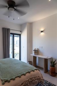 a bedroom with a bed with a ceiling fan at The Point At Cerritos # 4 in San Carlos +17 photos