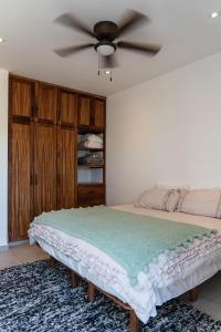 a bedroom with a bed with a ceiling fan at The Point At Cerritos # 4 in San Carlos