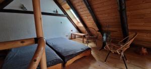 a bedroom with a bed and chairs in a cabin at Harlekin-Wohnung in Garbsen