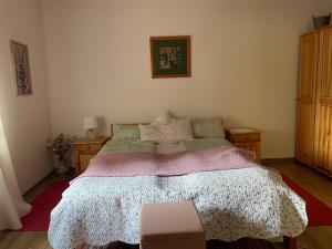 a bedroom with a bed and two night stands at Agroturystka Dom w Owocowym Sadzie in Nowosielce Kozickie