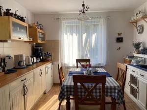 a kitchen with a table and a dining room at Agroturystka Dom w Owocowym Sadzie in Nowosielce Kozickie +23 photos
