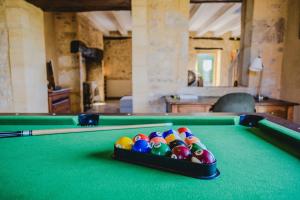 a pool table with billiard balls on top of it at Le Logis de Saint-Chamassy in Saint-Chamassy +33 photos
