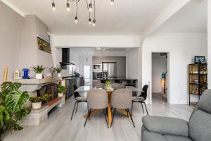 a kitchen and living room with a table and chairs at Private Room in Family Home with Pool in Sesimbra