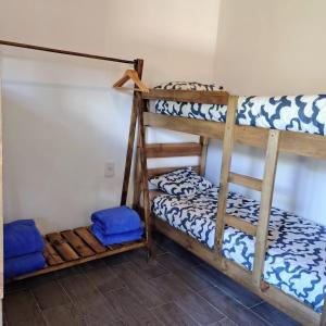 a room with four bunk beds in a room at Cabaña Regivan en Uspallata in Uspallata +12 photos