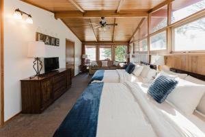 a large bedroom with two beds and a television at Happy Hollow Resort in Blue Eye