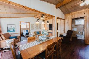 a kitchen and living room with a large wooden table at Happy Hollow Resort in Blue Eye