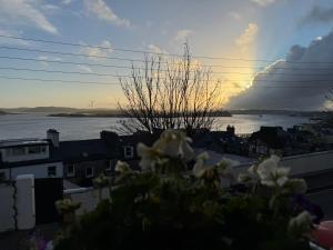 a sunset over the water with a cloud in the sky at The Sardinian Guesthouse (6 Bedrooms) in Cobh