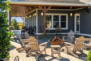 a patio with chairs and a fire pit in front of a house at Calaboose Retreat in Campton