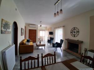 a living room with a couch and a fireplace at Cozy and calm in Dhílesi