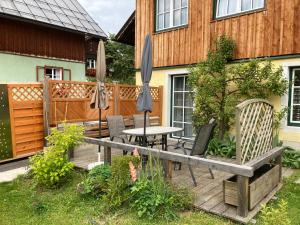 a patio with a table and chairs and umbrellas at FW Langanger in Fischerndorf