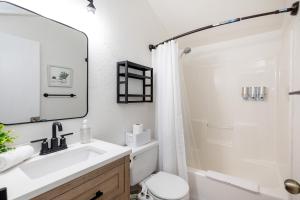 a bathroom with a sink and a toilet and a mirror at Whispering Pines: Foosball Grill More in Mountainaire +39 photos