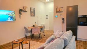 a living room with a couch and a table at Black Forest -5- I Design-Apartment I 2 Etagen I Terrasse & Balkon mit Ausblick I Boxspring I Nespresso in Oberharmersbach +13 photos