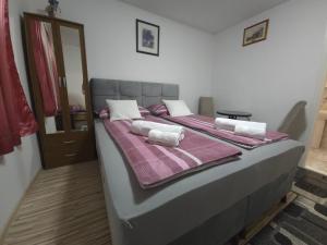 a bedroom with a large bed with pillows on it at Guest House Nana in Mostar