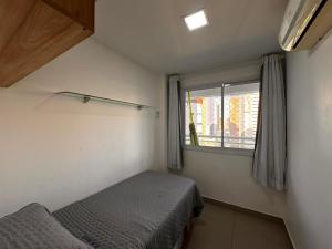 a small bedroom with a bed and a window at Apartamento 2 quartos Meireles a uma quadra da Beira-mar - My Way in Fortaleza +131 photos