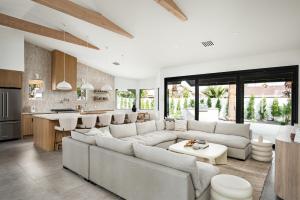 a living room with a large couch and a kitchen at The MYAH by Porter NEWLY REMODELED Enjoy the Pool Firepit Luxury in Phoenix