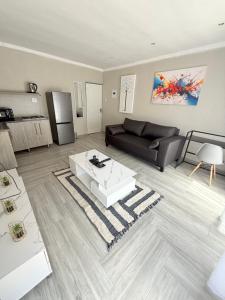 a living room with a couch and a coffee table at The Pool_deck apartment in Lebowakgomo