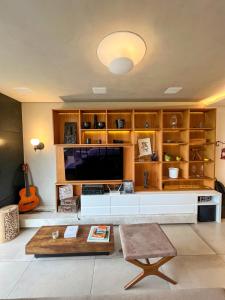 a living room with a tv and a table at luxstudiocampeche in Florianópolis