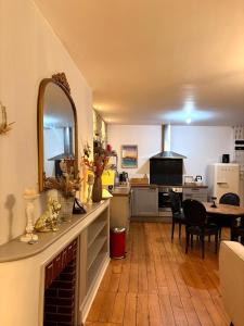 a kitchen with a table and a dining room at L'Idéal - charme de l'ancien et modernité - Hyper Centre in Vannes