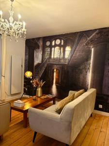 a living room with a couch and a table at L'Idéal - charme de l'ancien et modernité - Hyper Centre in Vannes +7 photos